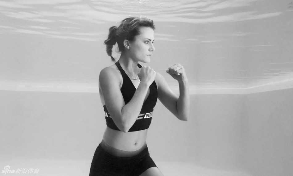 汤普森身着白色拳击袍悬浮水中，神情坚毅模仿阿里经典站姿，身后碧波如丝绸般流淌